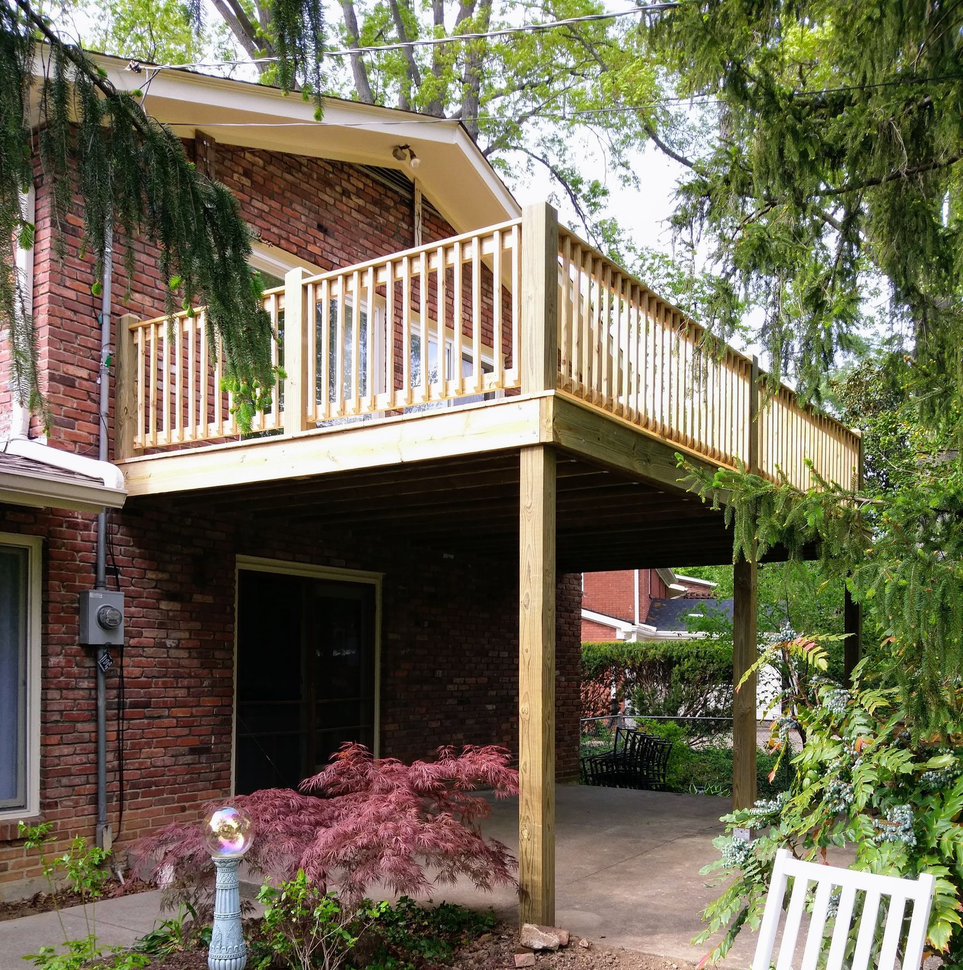 A brick house with a wooden deck underneath it