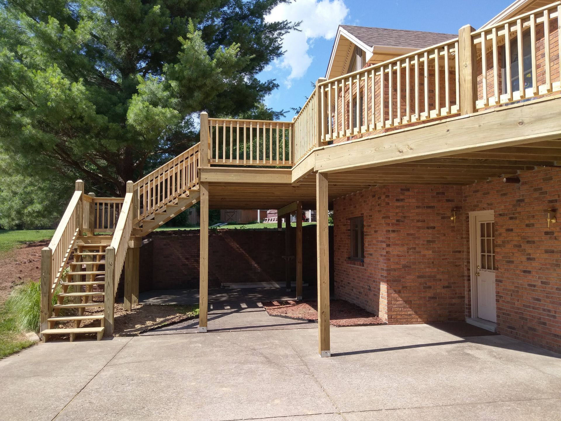 A brick house with a wooden deck and stairs