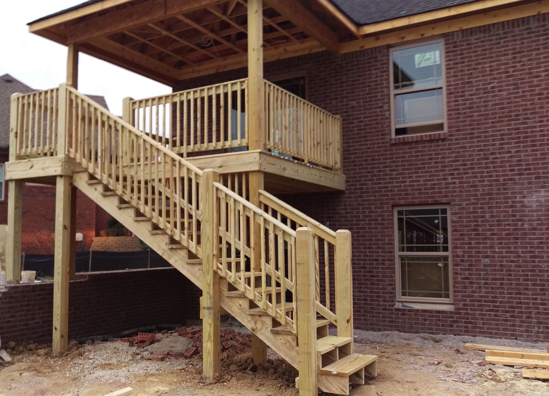 A wooden deck with stairs leading up to it