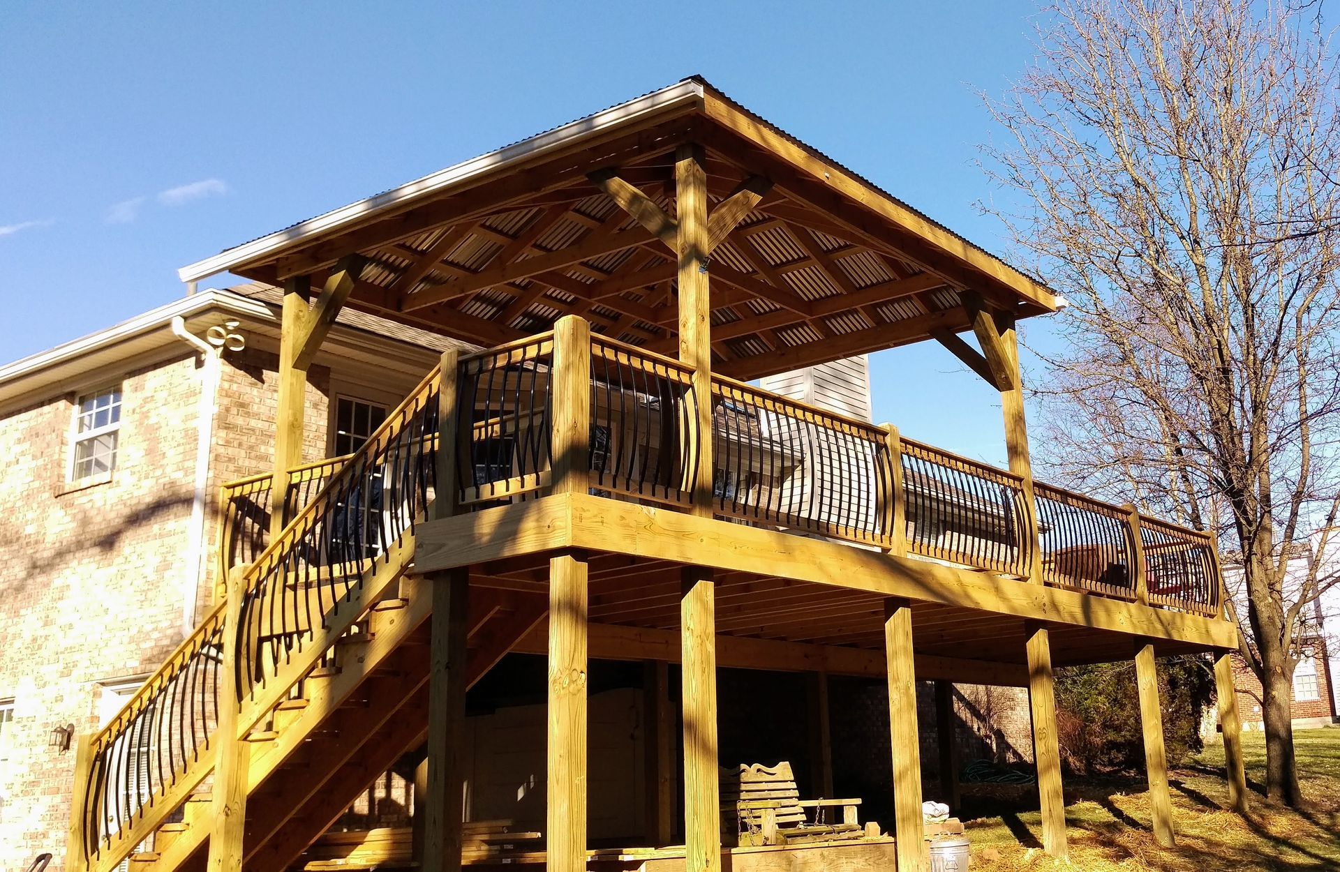 A large wooden deck with stairs leading up to it