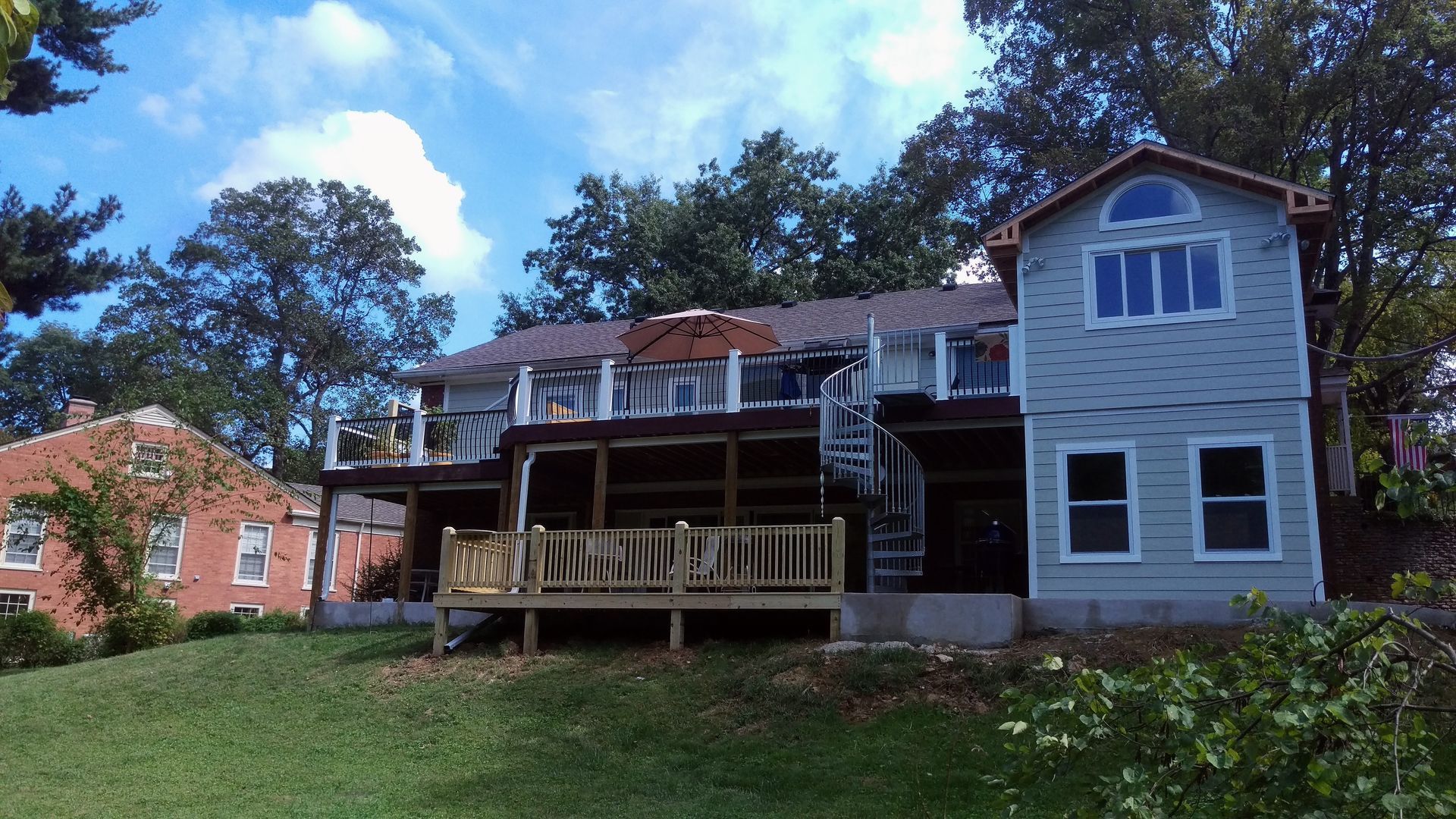 A large house with a large deck in front of it