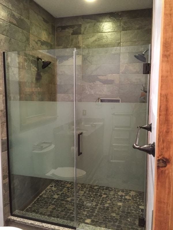 A bathroom with a walk in shower and a toilet.