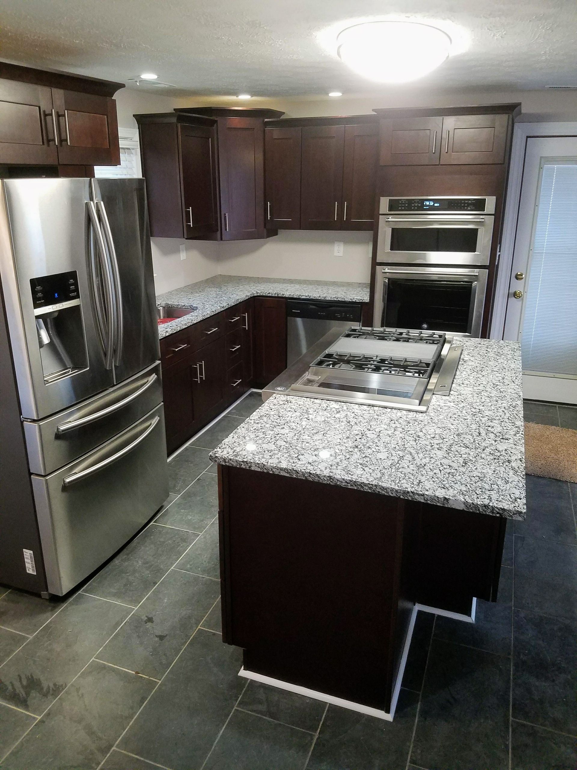 A kitchen with stainless steel appliances and granite counter tops