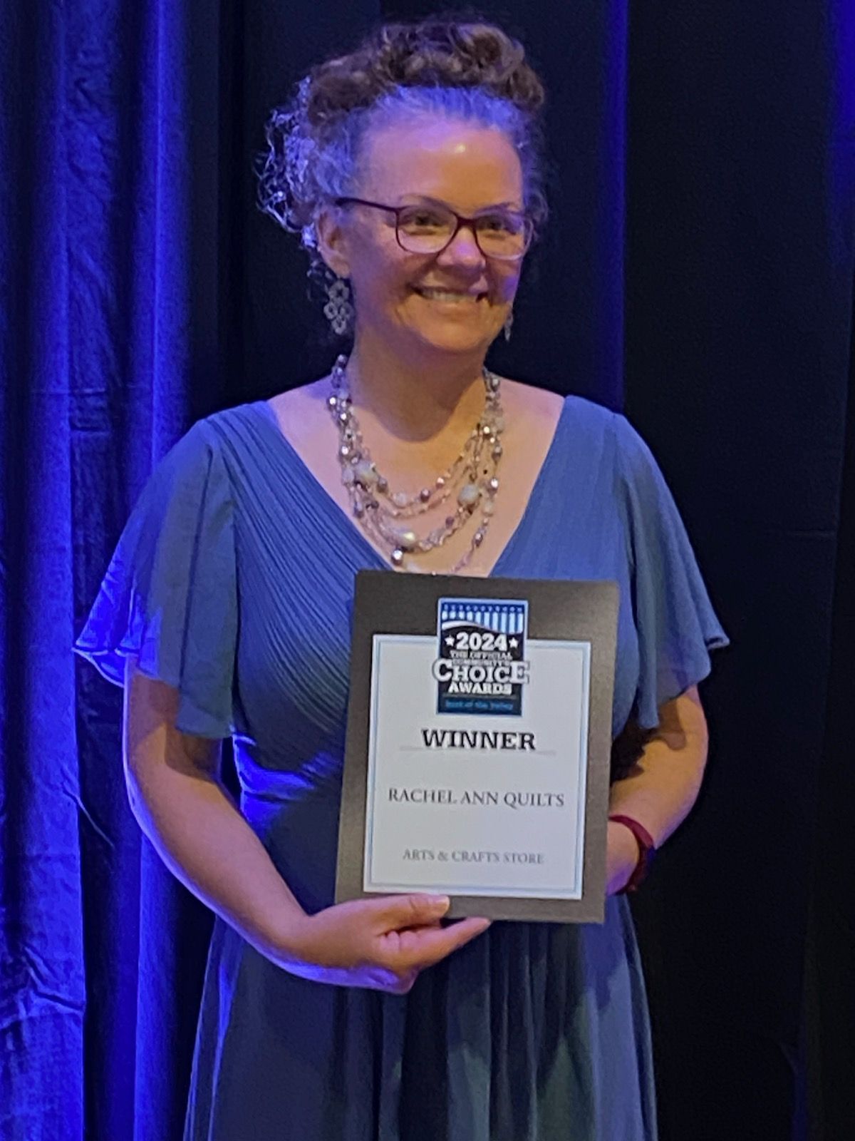 Rachel Ann the founder and owner of Rachel Ann Quilts with Winner certificate for Best of the Valley Arts and Crafts Store