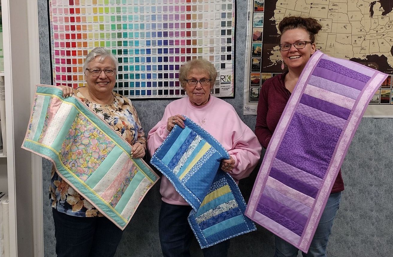 Flip N Stitch Table Runner Class Participants are all happy at Rachel Ann Quilts