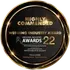 Circular black award badge with gold trim;
