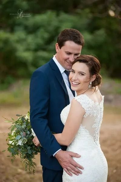 Bride and Groom Embrace Outdoors; She Smiles in a White Gown — Villa Lamor in Balberra, QLD