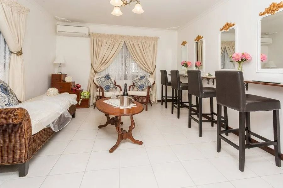 A Bright Room With a Seating Area, Makeup Stations, and a Couch — Villa Lamor in Balberra, QLD