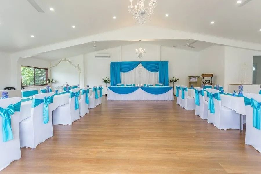 Event Hall Decorated in White and Turquoise. Tables Are Set, Stage Backdrop — Villa Lamor in Balberra, QLD