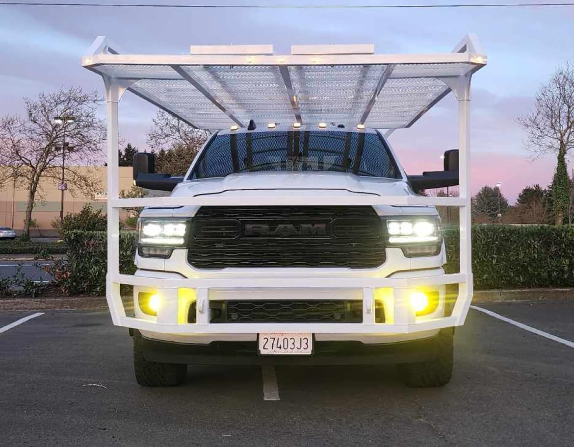 A white truck is parked in a parking lot.