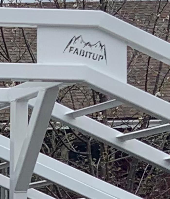 A close up of a white metal structure with a logo on it.