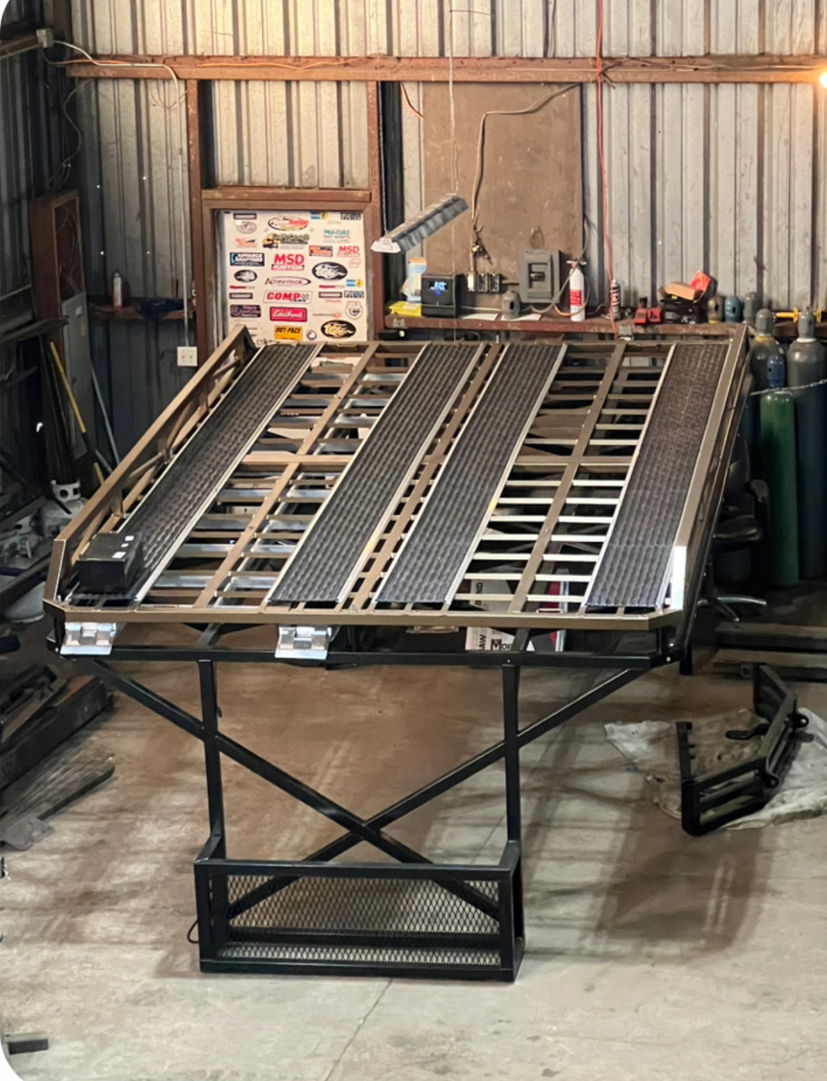 A large metal table is sitting in a garage.