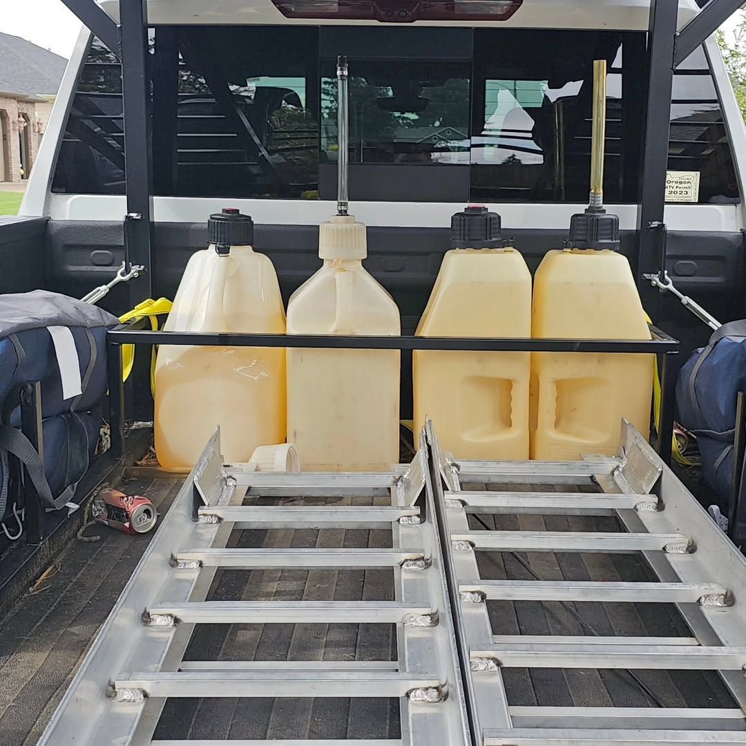A truck with a ladder and a bunch of bottles in the back