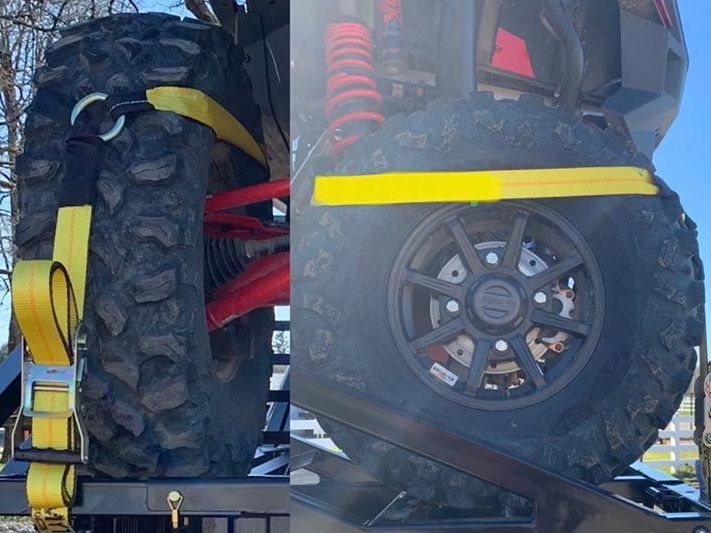 A large tire is attached to the back of a vehicle.