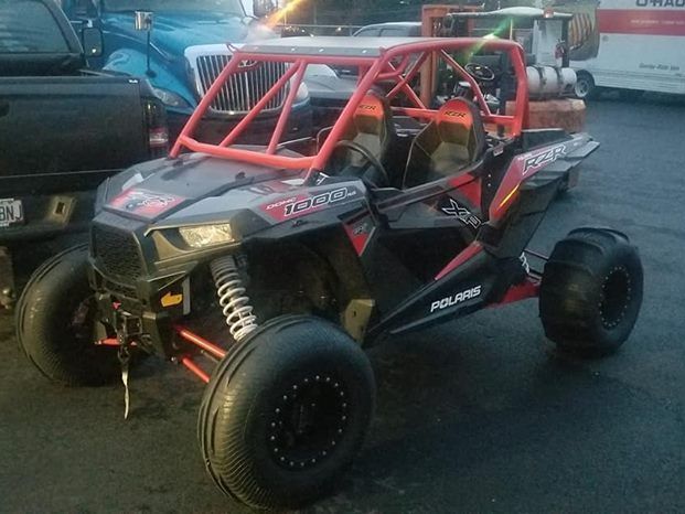 A polaris atv is parked in a parking lot