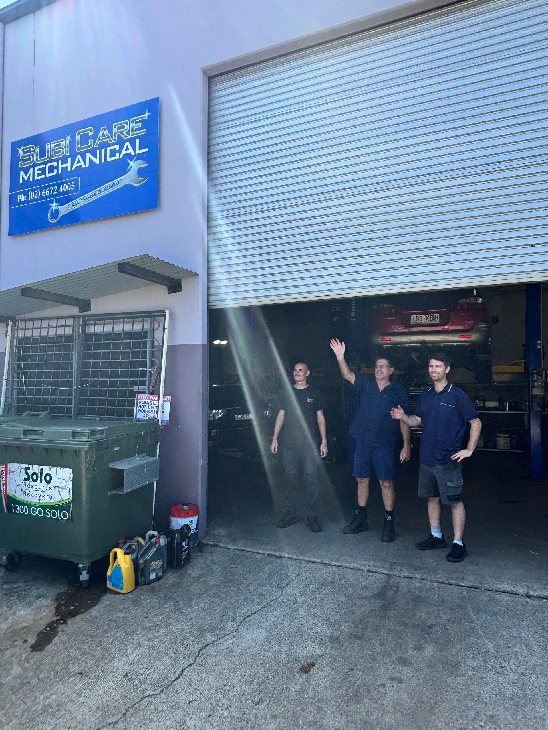 A Man Is Working On A Car Engine With A Wrench — Subi Care Mechanical In South Murwillumbah, NSW