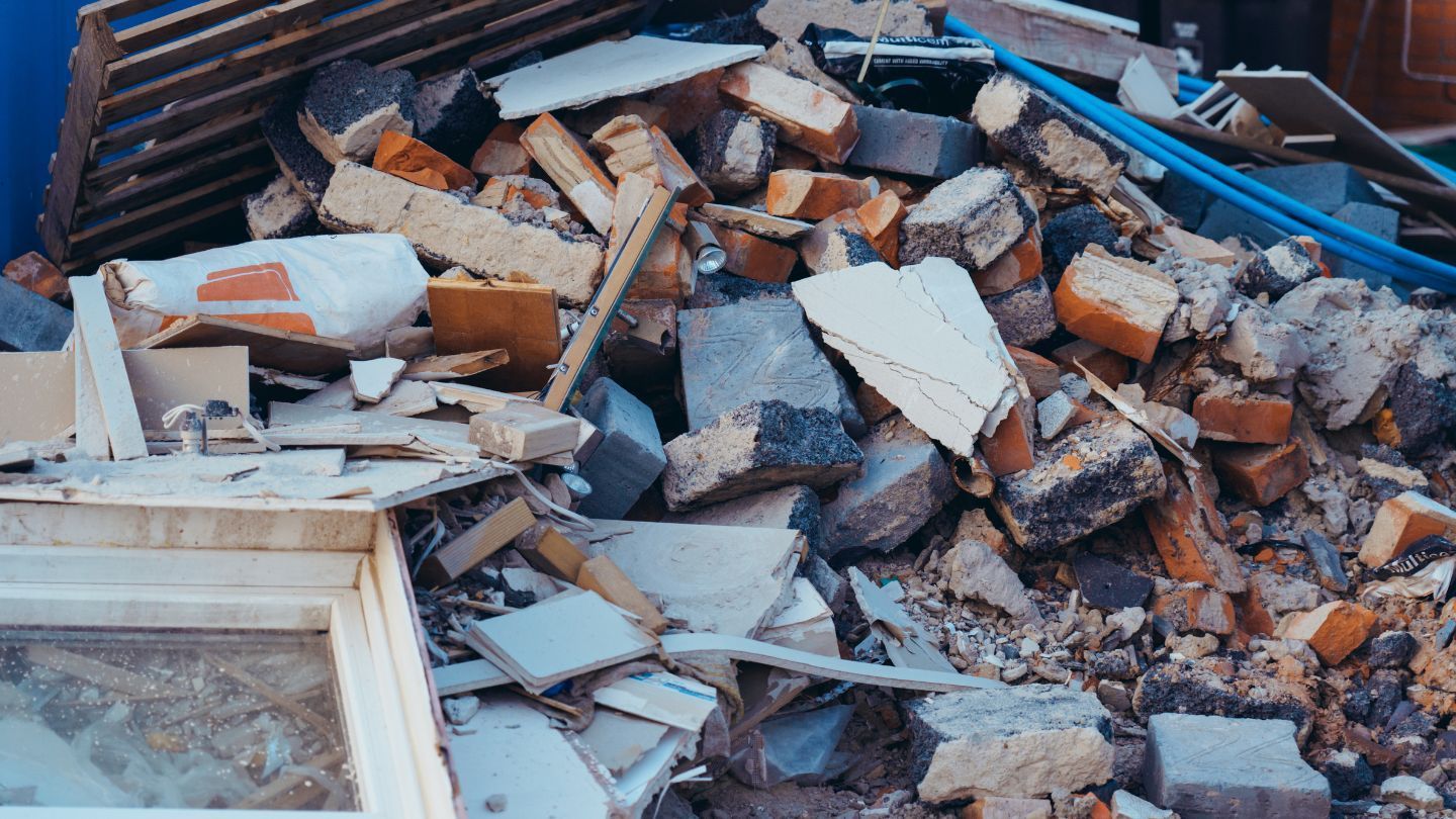 Pile of rubble: bricks, wood, and concrete debris; demolition aftermath.