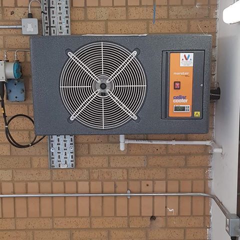 air conditioning unit on outside wall of building