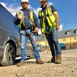 two workmen holding equipment