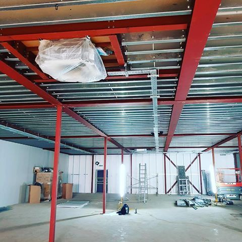 wrapped up air conditioning unit on the ceiling of an open space