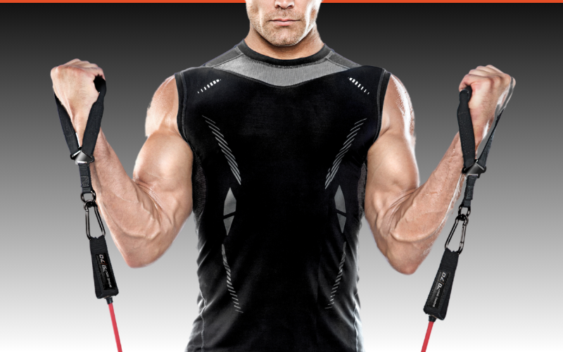 A man in a black tank top is holding a pair of resistance bands