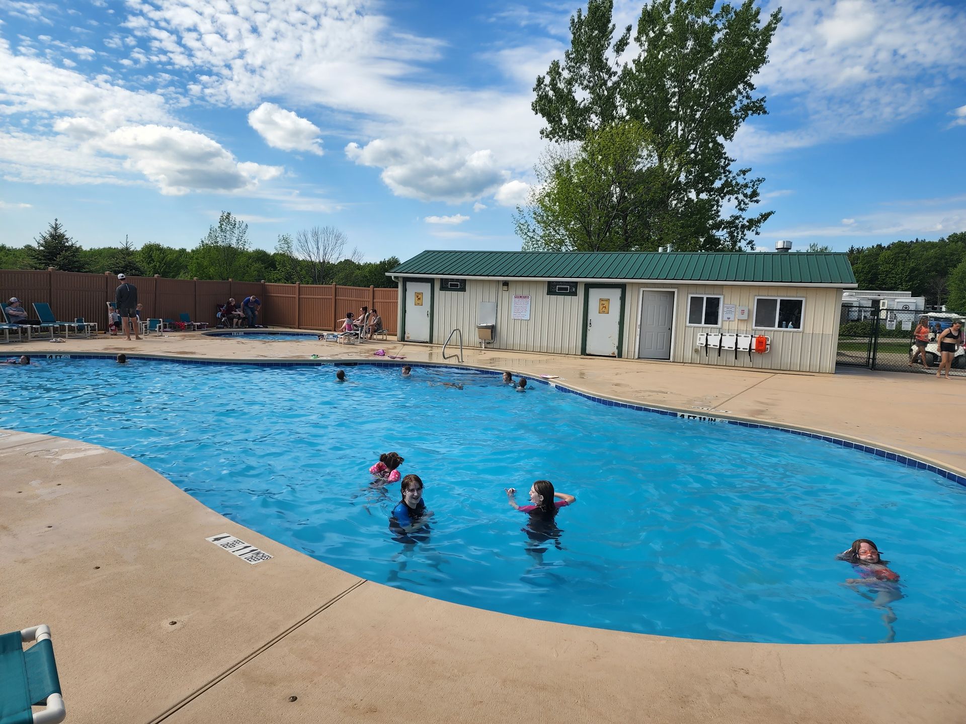 a group of people are swimming in a large swimming pool .