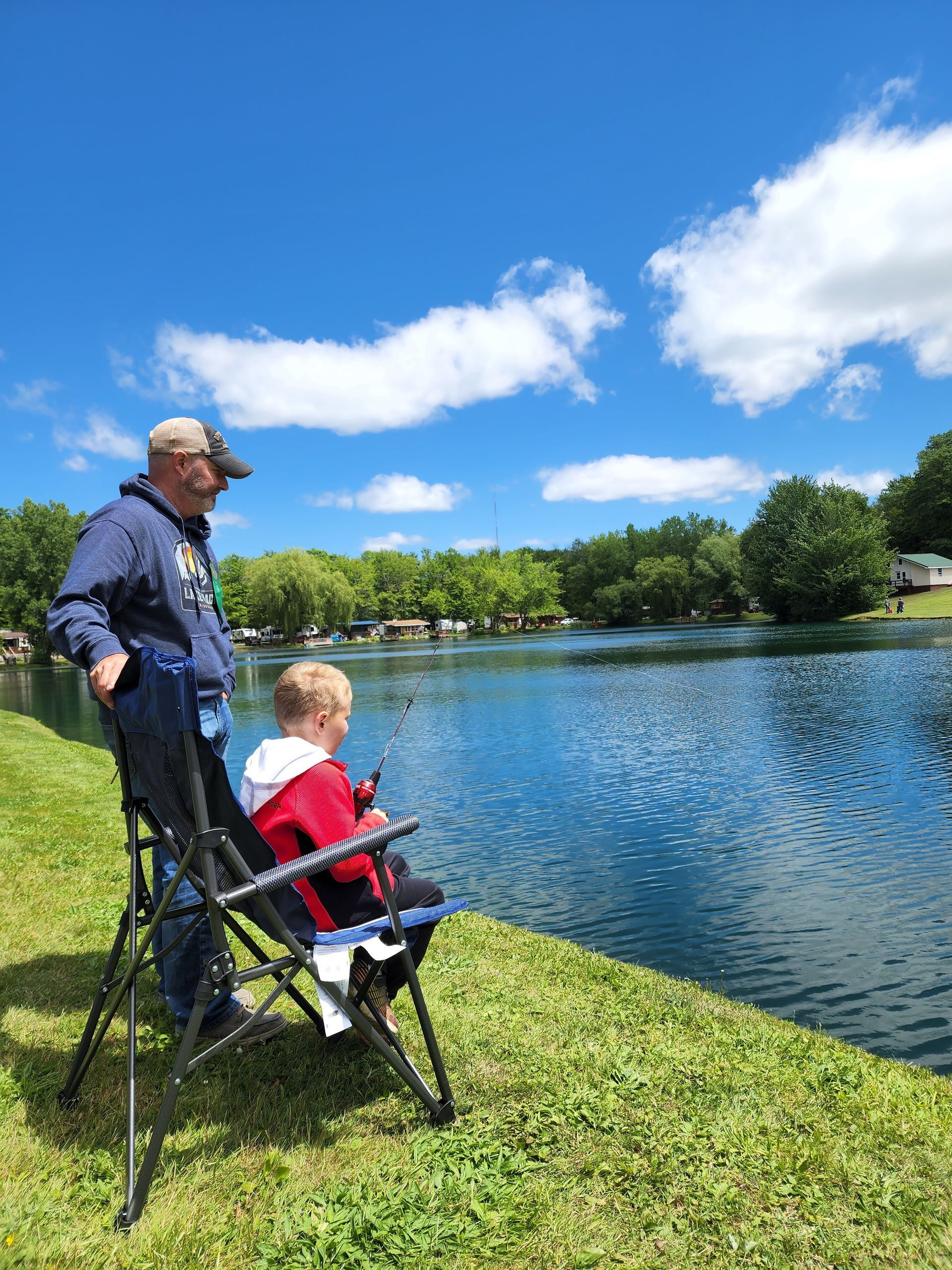 a man and a child are fishing in a lake .