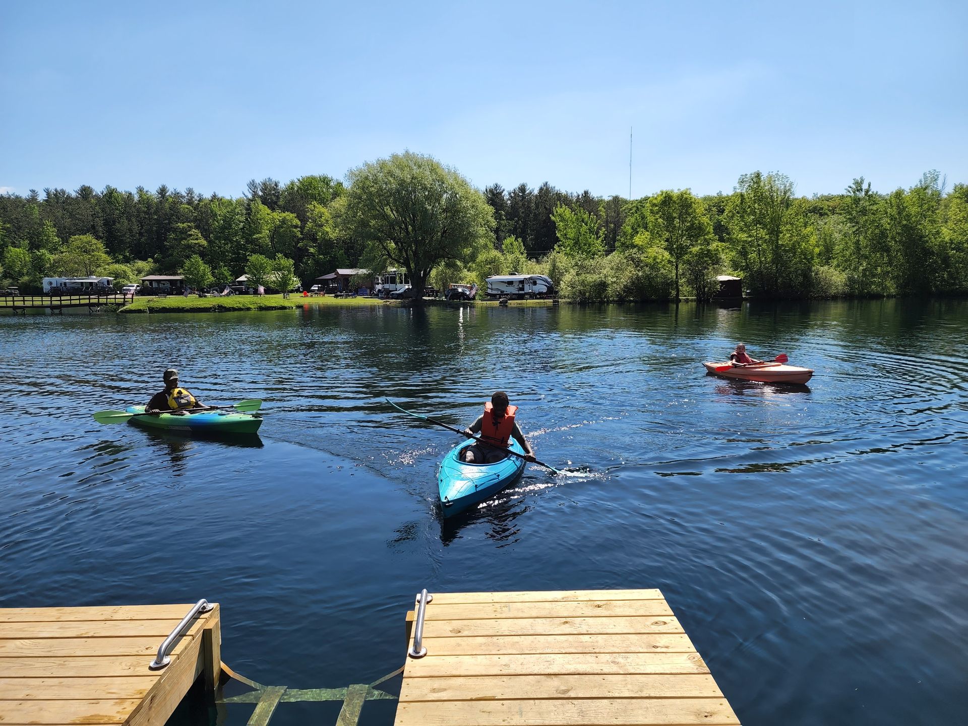 a group of people are paddling kayaks on a lake