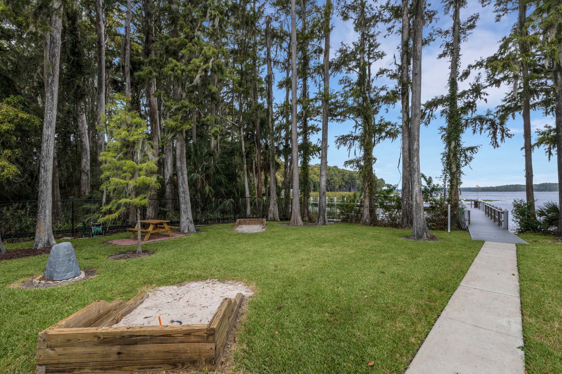 Hands passing house keys, blurred living room background.