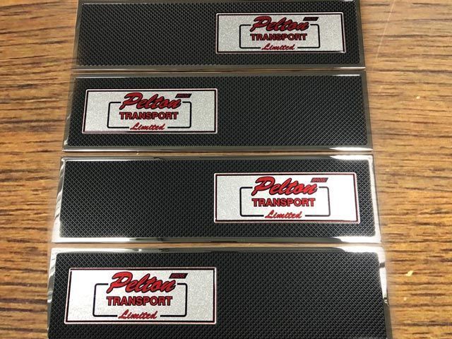 Four rectangular name badges with 