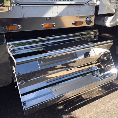 Chrome step on a truck, with lights and a shiny finish.