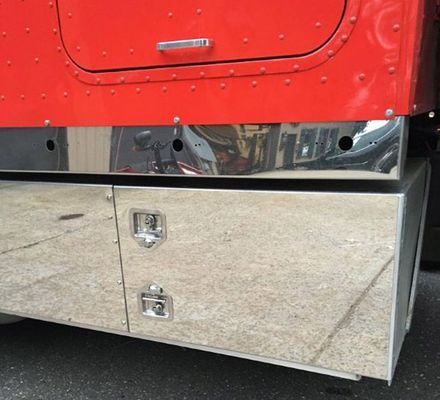 Red truck cab with chrome storage box.