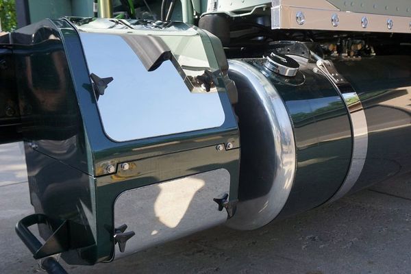 Green semi-truck detail with chrome panels. Dark fuel tank, and shiny surface.