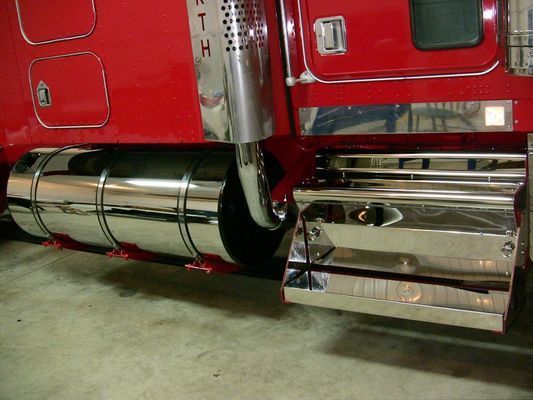 Chrome-plated exhaust and fuel tank on a red semi-truck.