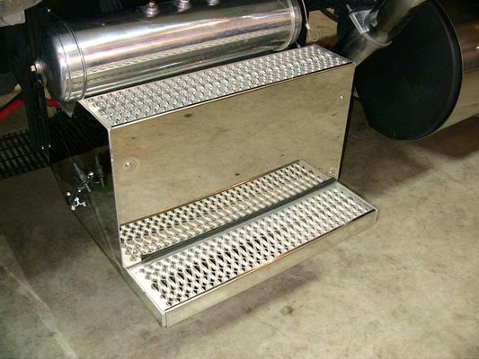 Stainless steel step platform with a diamond plate pattern and an air tank mounted on top.