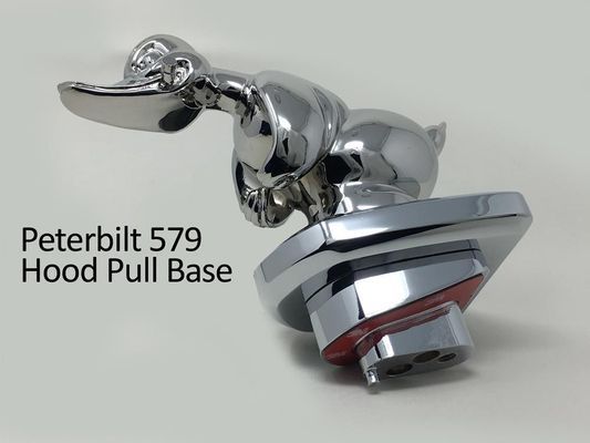 Chrome duck hood pull base for a Peterbilt 579 truck.
