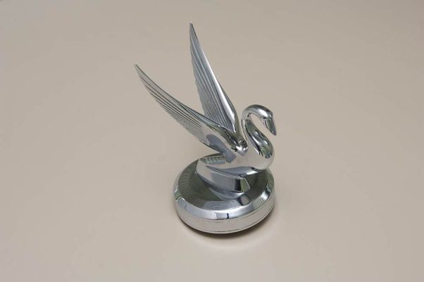 Chrome swan hood ornament on a car.