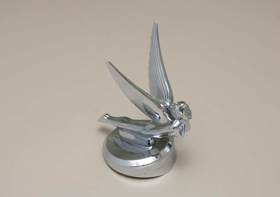 Silver car hood ornament depicting a winged figure in flight.