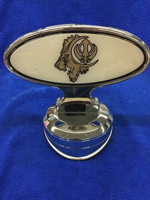 Chrome car hood ornament with a boar emblem.