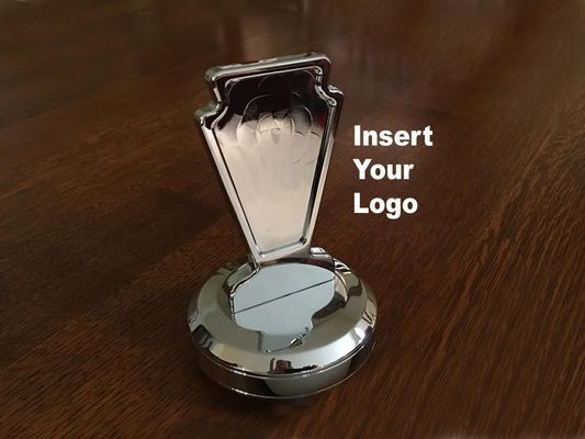 Shiny, silver metal desktop phone holder with space for a logo on a dark wood surface.