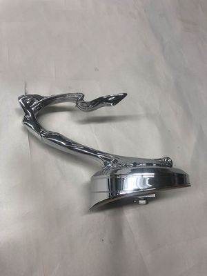 Chrome hood ornament of a leaping woman.