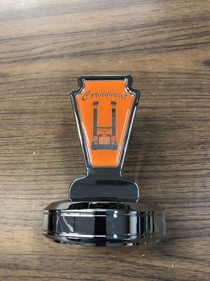 Orange and black commemorative trophy with a stylized 