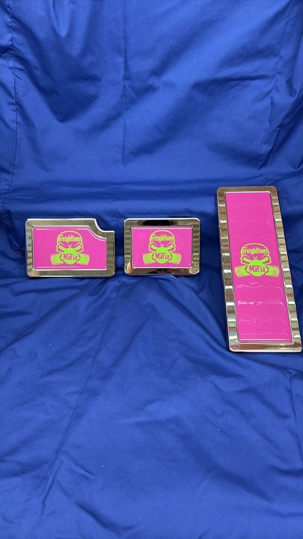 Three pink, rectangular toy pieces with green frog graphics on a blue background.