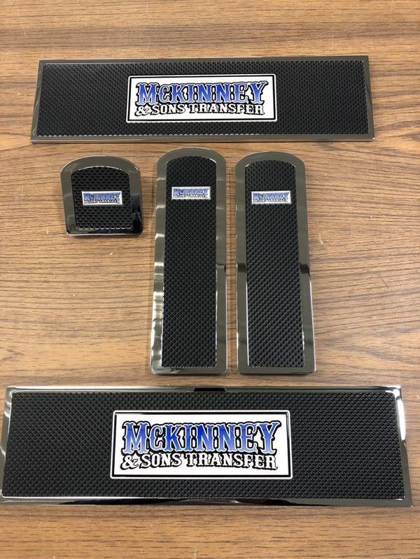 Set of custom vehicle interior trim pieces with carbon fiber texture and logo 