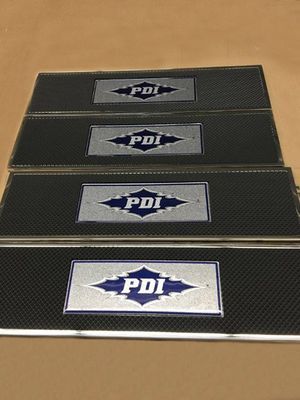 Four rectangular black mats with silver trim, each displaying a