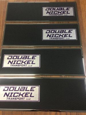 Four rectangular black and silver metal signs. Each features