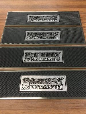 Four black rectangular mats with