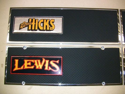 Two license plate frames with black mesh backgrounds, chrome borders, and nameplates reading