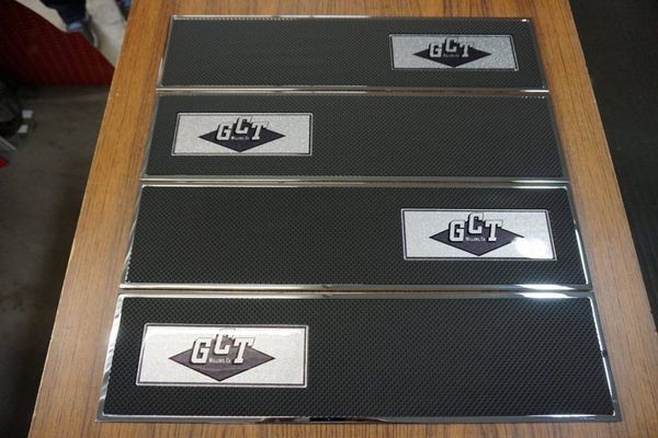 Four black panels with chrome trim and