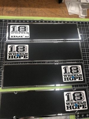 Four rectangular license plates with the